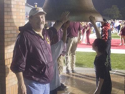 Bulldog Alum Larry Marfechuk is shown near the new "Victory Bell" he helped restore last fall