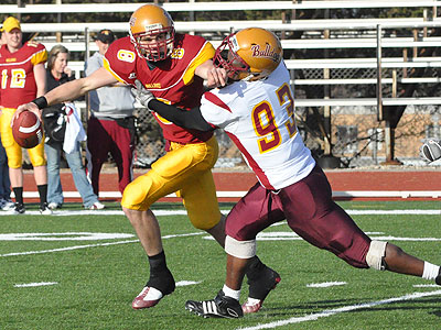 Redshirt freshman quarterback Taylor Masiewicz tries to elude the pressure applied by Michael Perdue (Photo by Rob Bentley)