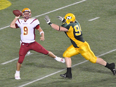 FSU quarterback Tom Schneider is pressured in Saturday's loss at Northern Michigan (Photo by Rob Bentley)