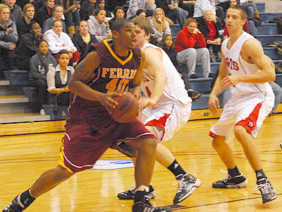 Justin Keenan drives to the basket in the season opener at Lewis (Photo by Rob Bentley)