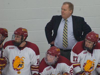 Radio announcer Dominic Hennig reviews the first-half season success experienced by head coach Bob Daniels and the Bulldog hockey team. (Photo by Joe Gorby)
