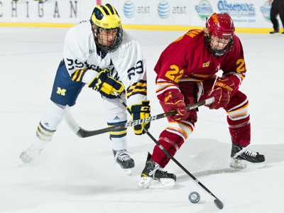 Derek Graham battles for the puck in Saturday's action at Michigan.  (Photo by Scott R. Galvin)