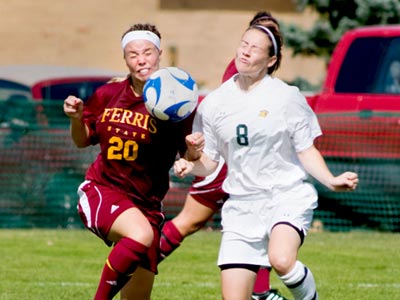 Sam Harrington and Northern Michigan's Dana Stephens collide in pursuit of the ball during Sunday's action.