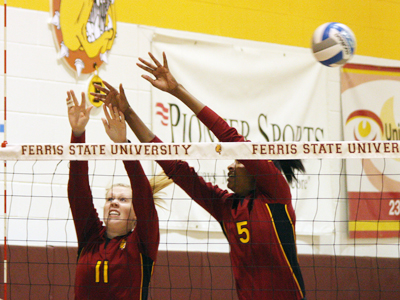 Samantha Fordyce and Arielle Goodson go up for a block attempt in Friday's action against Michigan Tech.  (Photo by The Pioneer)