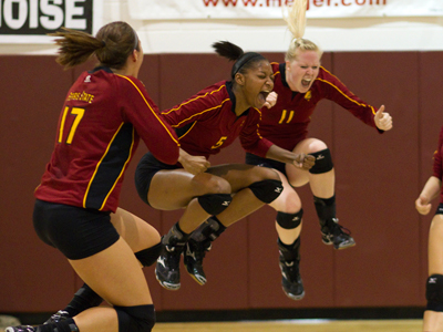 Aly Brecht (#17) and Samantha Fordyce (#11) celebrate Arielle Goodson's (#5) match-winning kill.  (Photo by Ben Amato)
