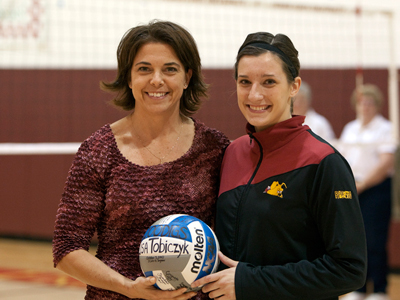 FSU head coach Tia Brandel-Wihelm presents Lisa Tobiczyk with a ceremonial ball to acknowledge her 1,000th career dig.  (Photo by Ben Amato)